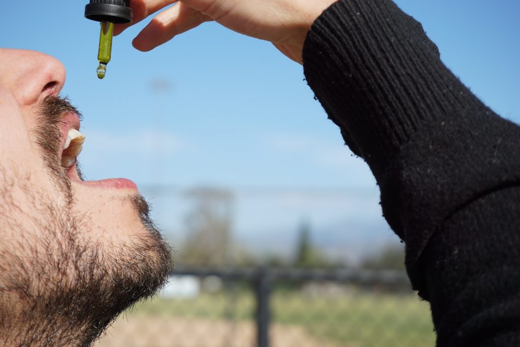 man in black long sleeve shirt holding green and yellow toy gun